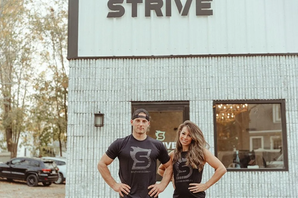 Chris and Amy Gosler, owners of STRIVE Fitness & Performance, outside the Duxbury gym