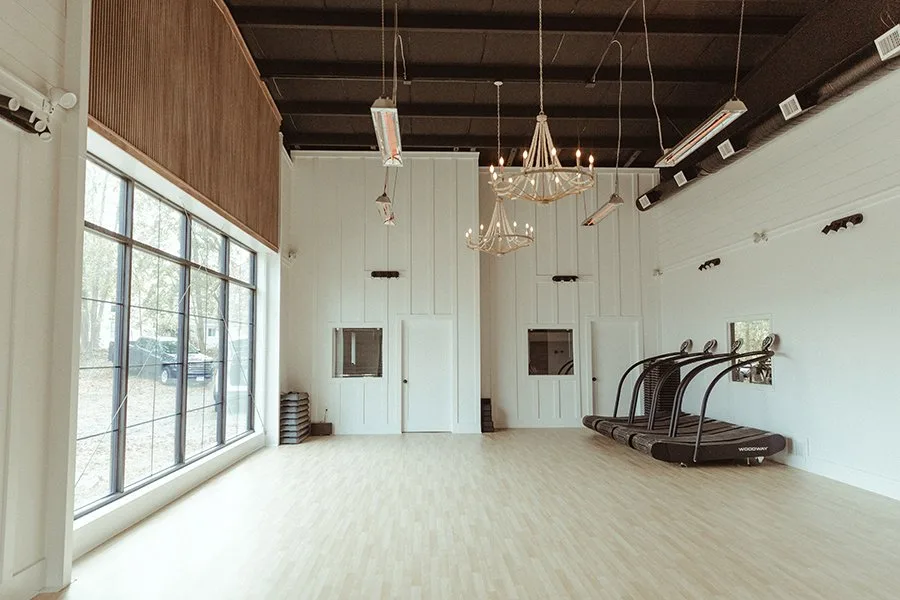 Bright STRIVE studio interior with treadmills